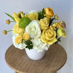 Yellow and white rose bouquet in a white vase