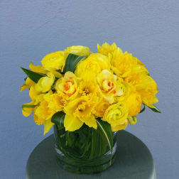 Yellow floral bouquet in a clear glass vase