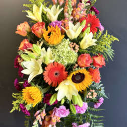 Tall mixed flower spray with lilies, gerberas, roses, and snapdragons