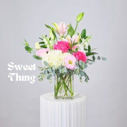 Pink and white bouquet in a clear glass vase