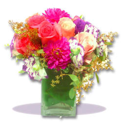 Colorful bouquet of roses and dahlias in a green glass vase