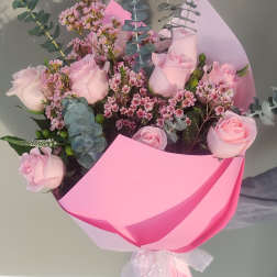 Pink rose bouquet wrapped in bright pink paper
