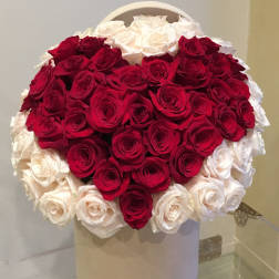 Heart-shaped bouquet of red and white roses in a white box