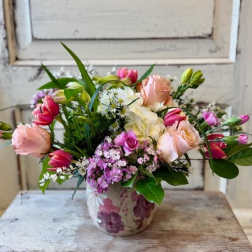 Mixed pink and white flower arrangement in a ceramic vase