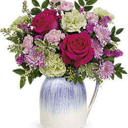 Bouquet of pink and white flowers in a blue ceramic vase