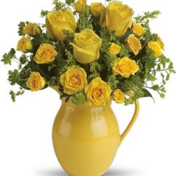 Yellow roses arranged in a yellow pitcher vase