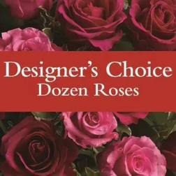 Dozen roses in shades of pink and red with a text banner across the center