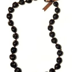 Dark bead necklace with a small brown ribbon bow at the top