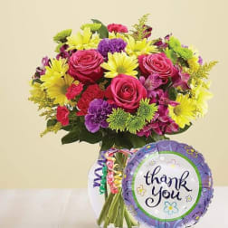 Mixed bouquet in a glass vase with a thank-you balloon