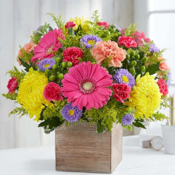 Colorful mixed flower arrangement in a wooden box