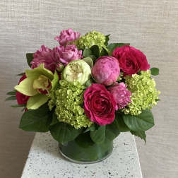 Pink and green floral arrangement in a glass vase