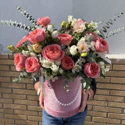 Pink roses and white blooms in a pink hatbox with pearl trim