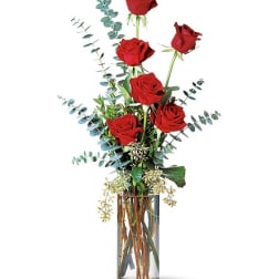 Tall vase arrangement of red roses with airy eucalyptus