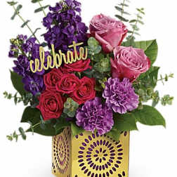Bouquet of pink and purple flowers in a decorative yellow box