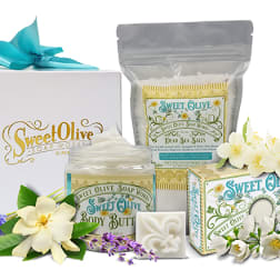 Sweet Olive Soap Works gift set with boxed bath products and flower decorations