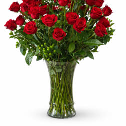 Red roses arranged in a clear glass vase