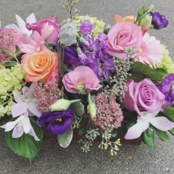 Mixed bouquet of pink, purple, and peach flowers
