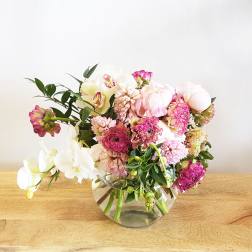 Pink and white floral arrangement in a clear glass vase
