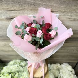 Bouquet of red and pink roses wrapped in pink paper