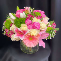 Pink and cream mixed bouquet in a clear glass vase
