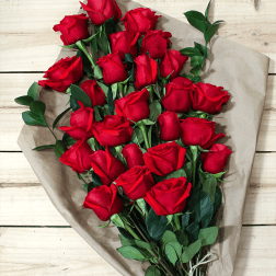 Bouquet of red roses wrapped in brown paper