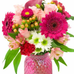 Pink and white mixed bouquet in a pink glass vase