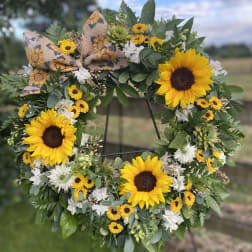 Sunflower wreath with white flowers and a burlap bow