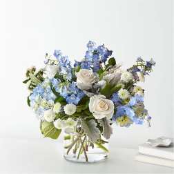 Blue and white bouquet in a clear glass vase