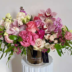 Pink and blush floral arrangement in a metallic vase