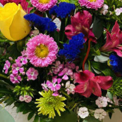 Bright mixed bouquet with yellow rose, pink and blue flowers