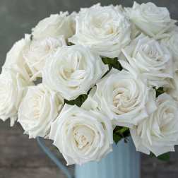 Bouquet of white roses in a pale blue vase