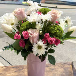 Pink roses and white daisies in a pink vase
