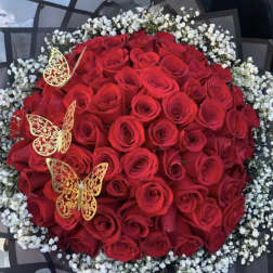Round bouquet of red roses with white baby's breath and gold butterfly accents