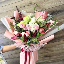 Pink and white mixed bouquet wrapped in pastel paper