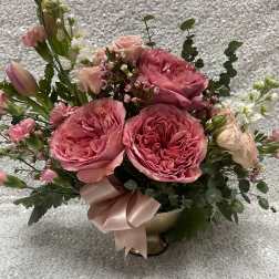 Pink rose bouquet in a gold vase with a satin ribbon