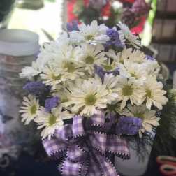 White daisy bouquet with purple accents and a plaid ribbon