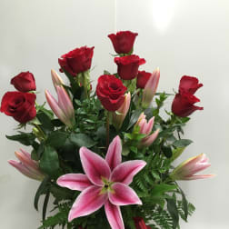 Bouquet of red roses and pink lilies with a red ribbon