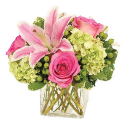 Pink lilies and roses in a clear glass vase