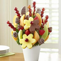Fruit bouquet in a white vase with strawberries and chocolate-dipped fruit