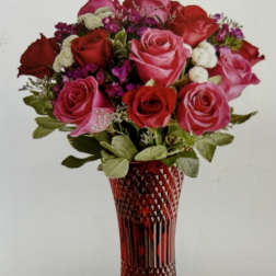 Bouquet of red and pink roses in a red cut-glass vase