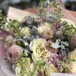 Bouquet of cream roses and pink chrysanthemums with silvery foliage