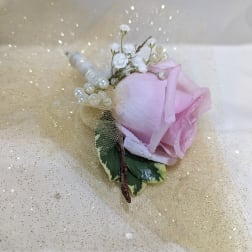Pink rose boutonniere with pearl accents and gold tulle wrap