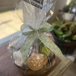 Wrapped gift basket with cookies and a ribbon bow