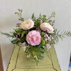 Pink ranunculus bouquet in a clear glass vase