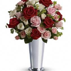 Bouquet of red, pink, and white roses in a silver vase