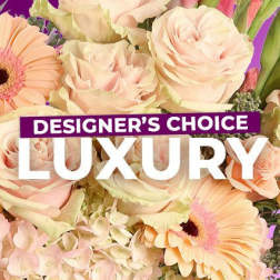Pastel bouquet with roses and gerbera daisies, overlaid with "Designer’s Choice Luxury" text