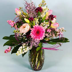 Mixed pink and white flowers in a glass vase