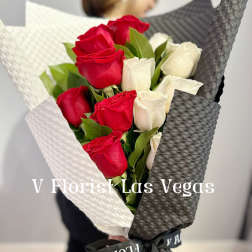 Bouquet of red and white roses wrapped in black and white paper