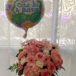 Pink flower bouquet with a "She's Cute As A Button" balloon