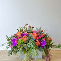 Bright mixed flower arrangement in a rectangular container